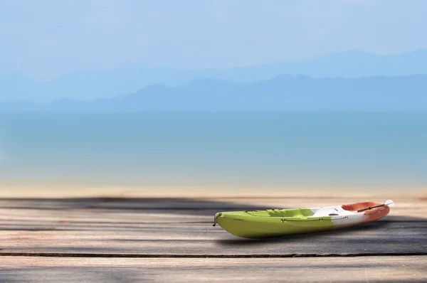 Kayak boat on plank on tropical beach background, display products idea — Stock Photo, Image