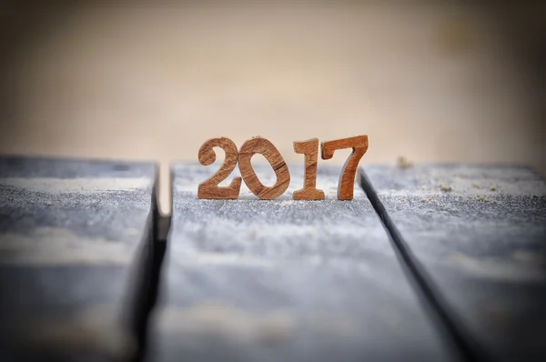 Wood number 2017 on plank and sand background — Stock Photo, Image