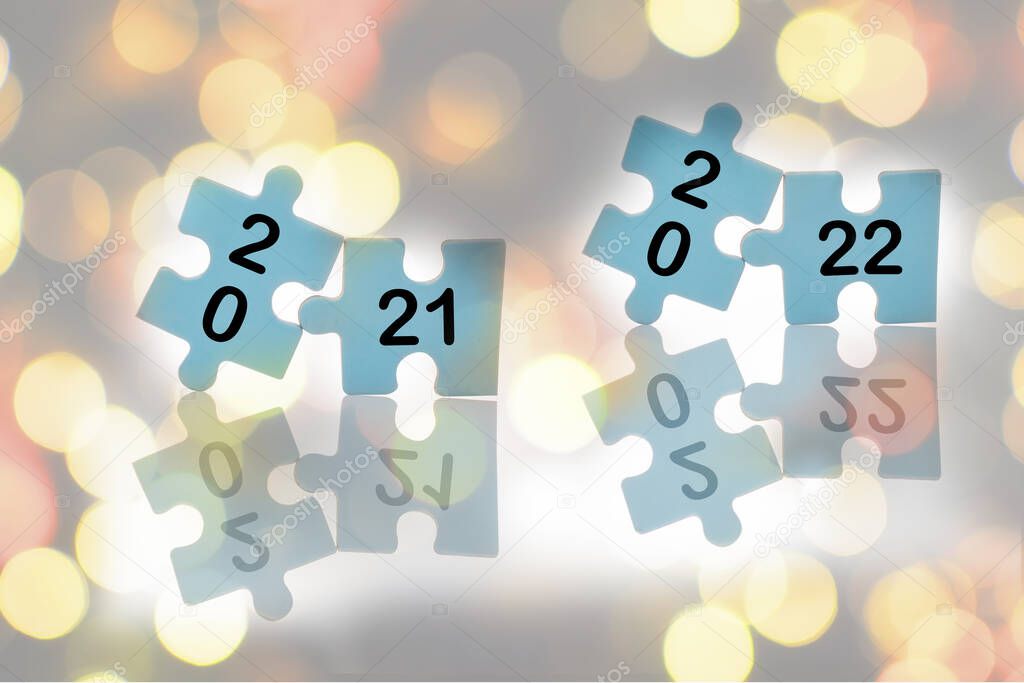 New year 2021 and 2022 on blue puzzle with reflection on abstract background, business success with challenge concept and keep trying idea