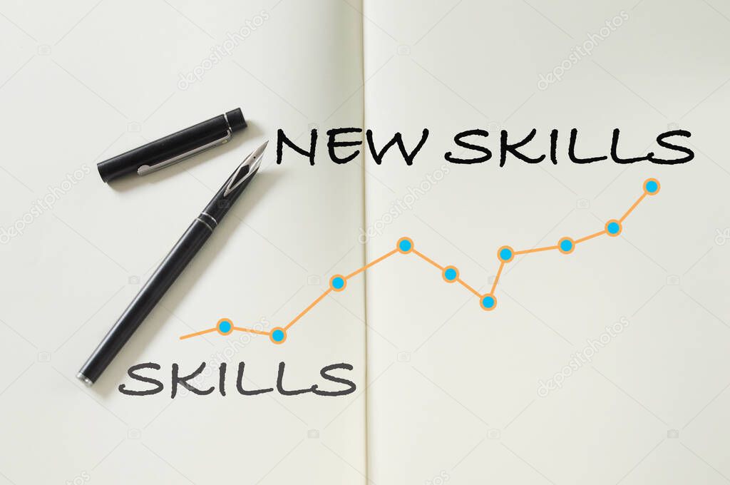 New skills written on notebook with fountain pen and growth graph. Education planning improvement concept and reskilling and upskilling idea