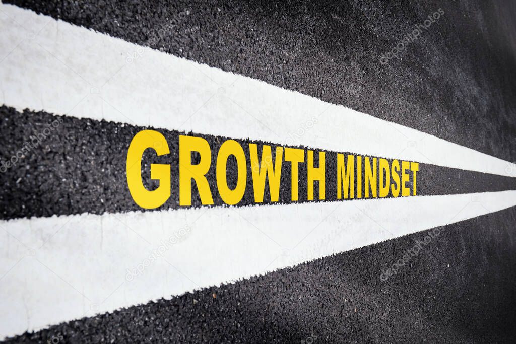 Growth mindset on asphalt road with marking lines for giving directions. Business success with future ahead concept. Self development to new skills