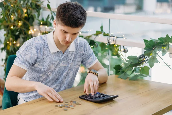 business, finance, accounting and people concept - man with money and calculator, counting profit or loss.