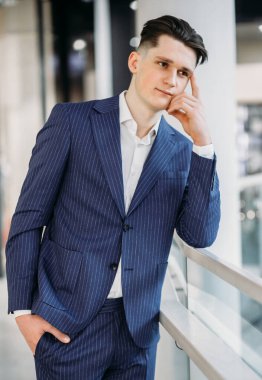 Yakışıklı genç dalgın işadamı, cebinde bir şeyler olduğunu düşünüyor..