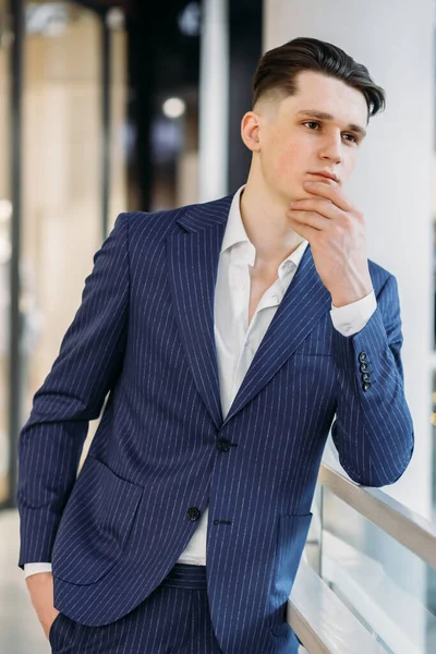 pensive young man in suit.