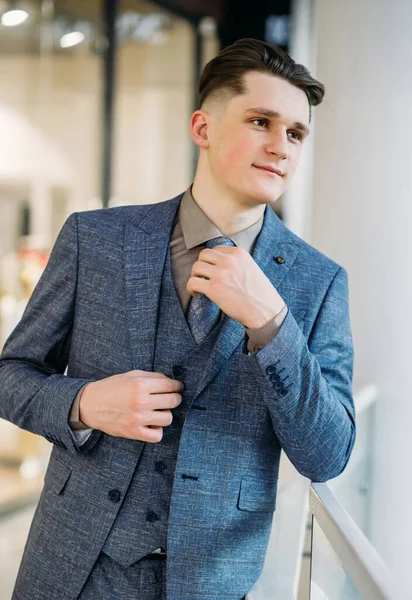 Stylish young man in a suit and tie. Business style. Fashionable image. Office worker. sexy man standing and looking to the side