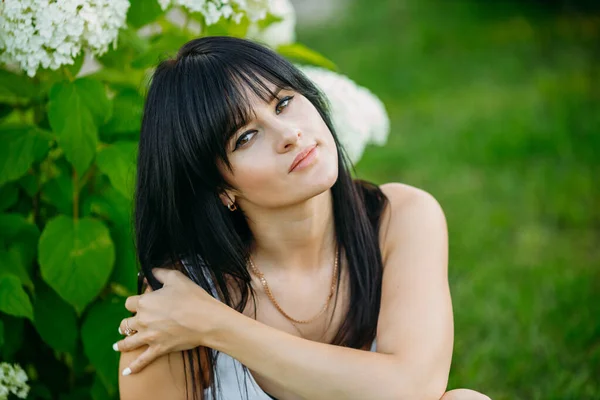 Outdoor closeup fashion portrait of young pretty woman in summer meadow