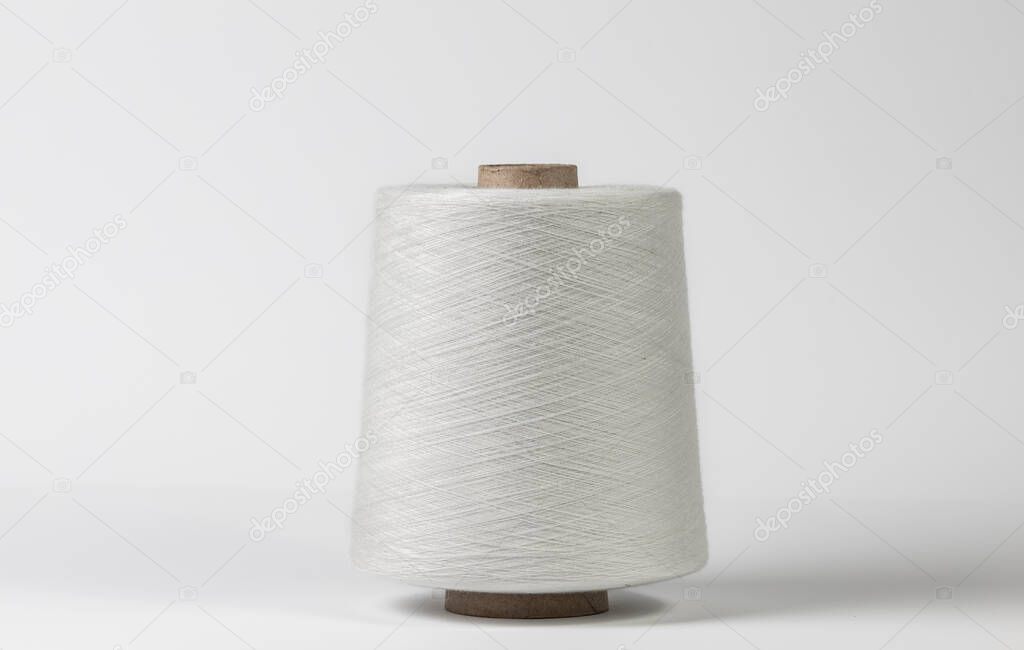 Textile white spool on isolated white background.