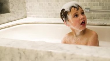 Little boy playing in the bath.