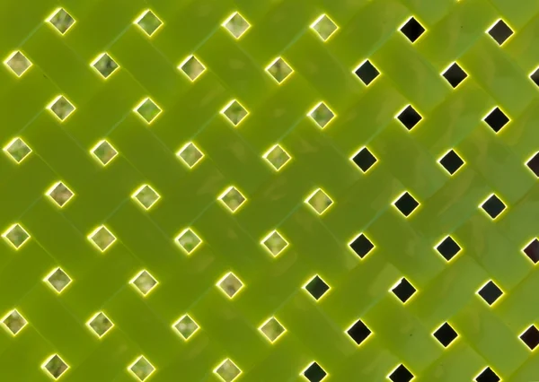 Vista astratta attraverso il pannello posteriore della sedia di plastica verde — Foto Stock
