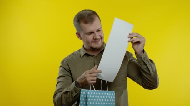 Joyful man showing Up To 70 percent Off inscription from shopping bag, smiling, rejoicing discount — Stock Video
