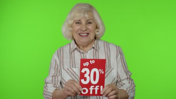 Senior grandmother showing Up To 30 percent Off inscription signs, rejoicing discounts. Black Friday — Stock Video