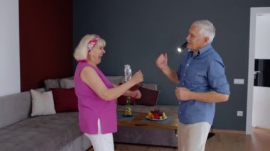 Yaşlı çift evde dans edip gülüyor. Büyükannem ve büyükbabam yıl dönümlerini kutluyor.