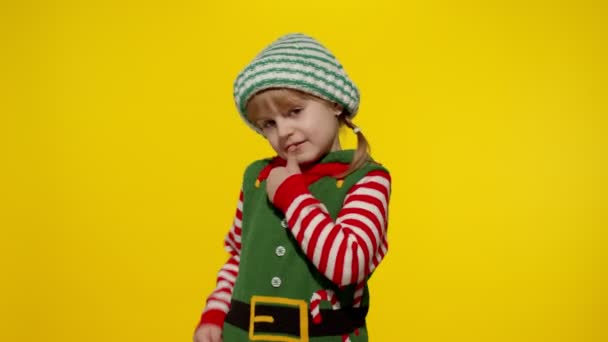 クリスマスの自己の子供の女の子の子供サンタヘルパーの衣装は、ジェスチャーを親指を表示します。年末年始 — ストック動画