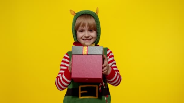 Kid girl Christmas elf Santa helper giving present gift box to camera. Happy New Year holidays — Stock Video