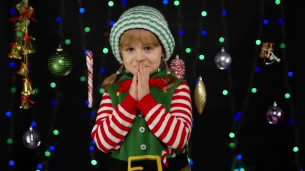 Concepto de deseo navideño. Niño adolescente chica en Navidad elfo Santa ayudante traje haciendo un deseo, reza — Vídeo de stock