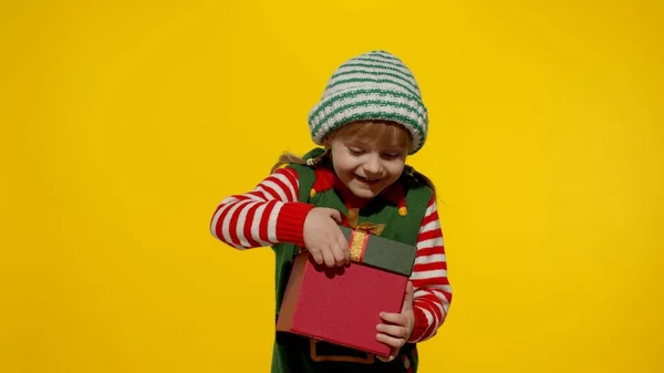 Kid girl in Christmas elf Santa helper costume getting, receiving present gift box. New Year holiday — Stock Photo, Image