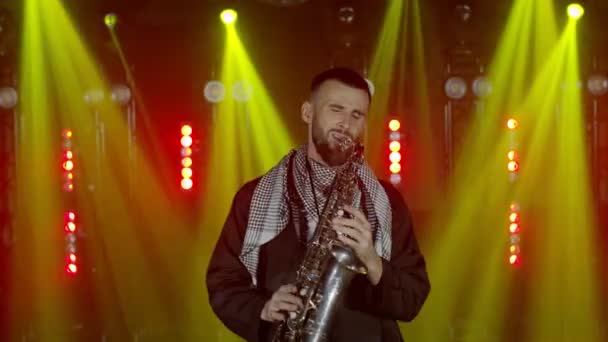 Actuación en vivo del saxofonista hombre con saxofón, bailando en concierto músico escenario con luces — Vídeo de stock