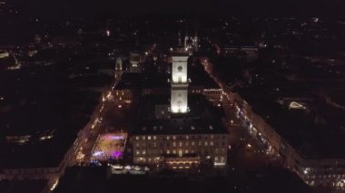 Lviv şehrinin Arial manzarası, Ukrayna Rynok meydanı, Noel panayırı, insanlar buz pateni pistinde kayıyor.