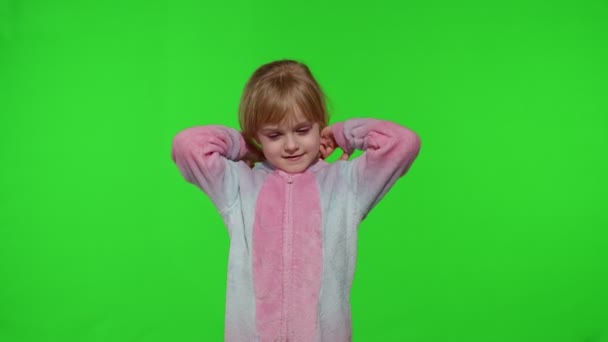 Child girl in unicorn pajamas making silly funny faces, fooling around, showing tongue on chroma key — Stock Footage Child girl in unicorn pajamas making silly funny faces, fooling around, showing tongue on chroma key Stock Video