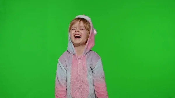 Portrait of little blonde child in unicorn costume crying with tears on chroma key background — Stock Photo, Image