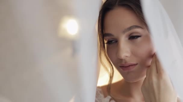 Novia en vestido de tocador bajo el velo y en una túnica de seda. Preparativos de boda mañana antes de la ceremonia — Vídeos de Stock