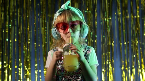 Stylish trendy child kid girl at disco party cyberpunk club with pineapple fruit drinking juice — Stock Video