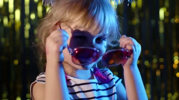 Hipster cute teenager children girl looking at camera, smiling at disco party club in neon lighting — Stock Video