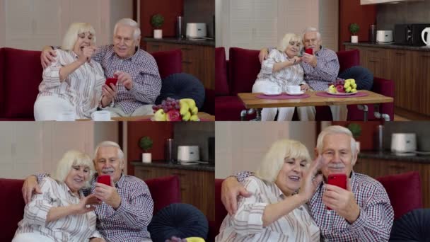 Ancianos abuelos de la vieja pareja hablando y usando la computadora del teléfono móvil en casa. Compras por Internet — Vídeos de Stock