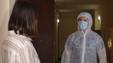 Aşı ampule sahip bir doktor, Coronavirus 'a karşı aşı öneren bir hastayı evinde ziyaret ediyor.