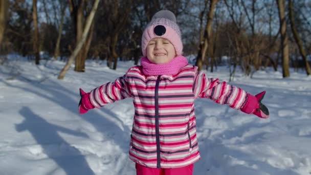 Smiling child kid looking at camera, embracing, fooling around, hugging in winter snowy park forest — Stock Video