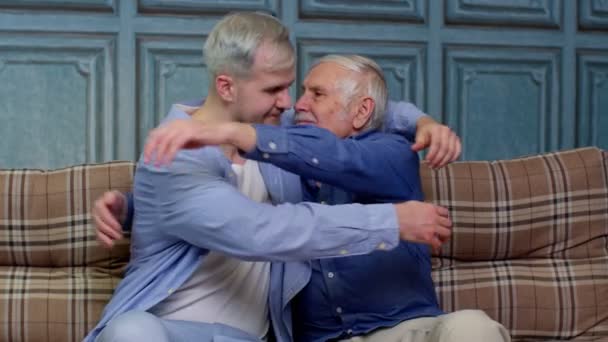 Joyful excited young man embracing gray-haired old dad or grandfather, male generations family