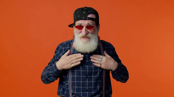 Mature old bearded grandfather in sunglasses showing wasting or throwing money around hand gesture
