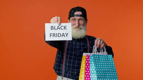 Anciano barbudo hombre mostrando Viernes Negro inscripción banner texto, descuentos en publicidad, precios bajos — Foto de Stock