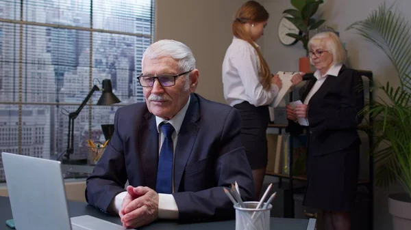 Focused senior business man entrepreneur typing on laptop doing research, sitting at office desk — Stock Photo, Image