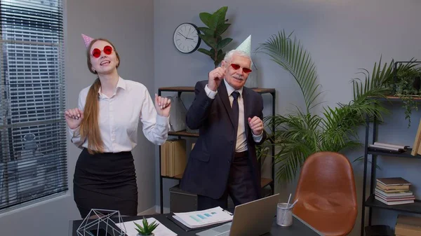 Two joyful collegues in formal suits dancing victory dance, celebrating success of business project — Stock Photo, Image