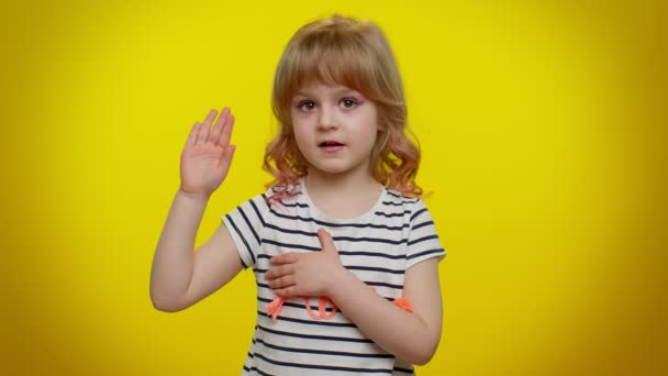 Criança jura ser honesta, levantando a mão para fazer juramento prometendo dizer a verdade mantendo a mão no peito — Vídeo de Stock