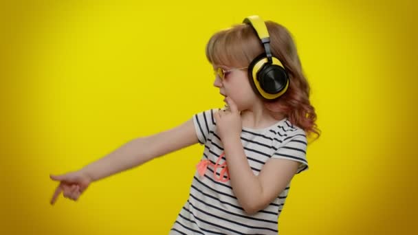 Funny playful blonde child kid listening music via headphones dancing disco fooling having fun party — Stock Video