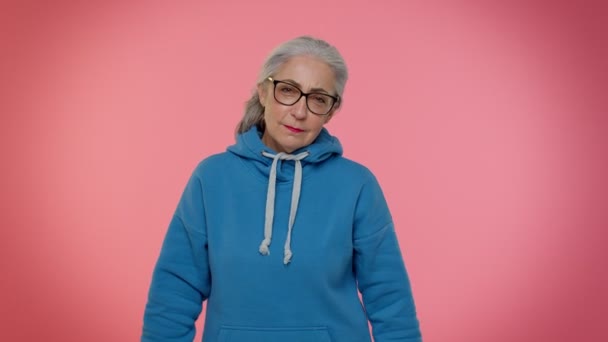 Tired sad upset senior old granny woman bored indifferent expression not interested in communication — Stock Video