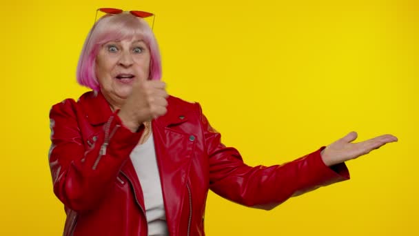 Volwassen grootmoeder tonen duimen omhoog en wijzen lege plaats, reclame gebied voor commerciële tekst — Stockvideo