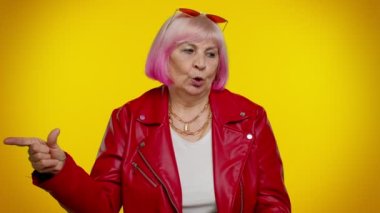 Yaşlı yaşlı kadın etrafta el tabancasıyla işaret ediyor, tabancayla öldürüyor.