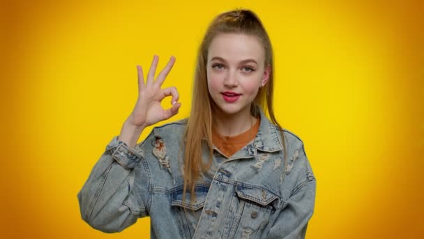카메라 를 좋아하는 10 대 소녀는 좋은 일에 대한 긍정적 인 서명 과같은 멋진 몸짓을 하고 있다 — 비디오