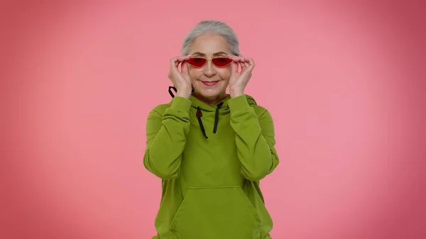 Retrato de anciano anciano seductor anciana abuelita mujer de pelo gris con gafas de sol, sonrisa encantadora — Foto de Stock