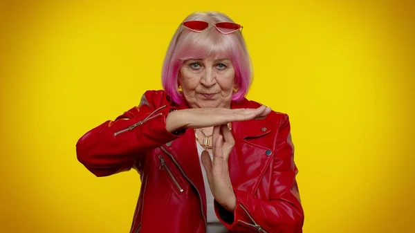 Anziano vecchio elegante rocker nonna donna con i capelli rosa che mostra il tempo fuori gesto, limite o stop segno — Foto Stock