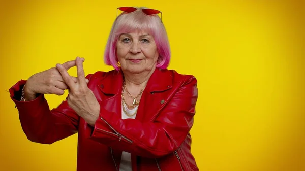 Cheerful senior old woman showing hashtag symbol, likes tagged message, follow internet trends