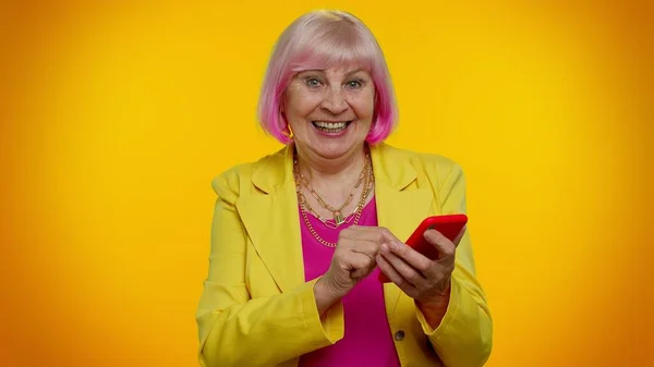 Senior old granny woman using mobile phone typing new post, sms message, browsing, social networks — Stock Photo, Image