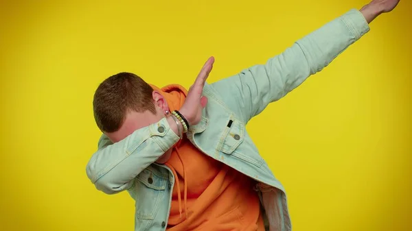 Trendy cheerful man dancing and moving to rhythm, dabbing raising hands, making dubdance gesture — Stock Photo, Image