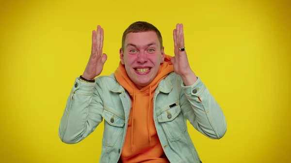 Crazy man in jacket with hoodie demonstrating tongue out fooling around, making silly faces, madness — Stock Photo, Image