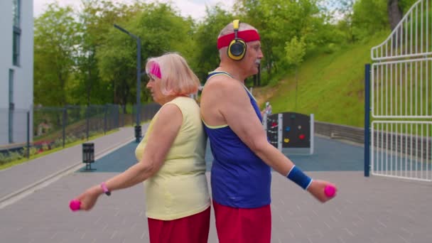 Aktiva äldre gamla idrottslag mormor morfar tyngdlyftning hantlar, ler mot kameran — Stockvideo
