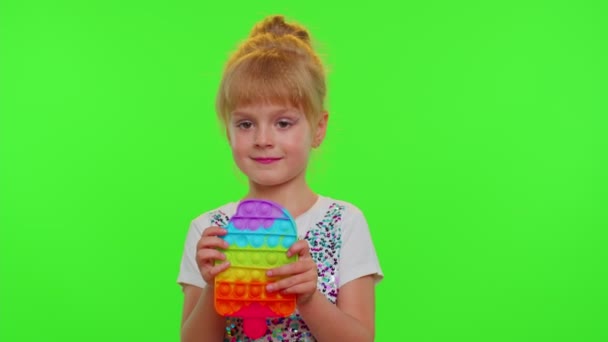 Cute girl playing with pop it sensory anti-stress toy, stress anxiety relief, chroma key background — Stock Video