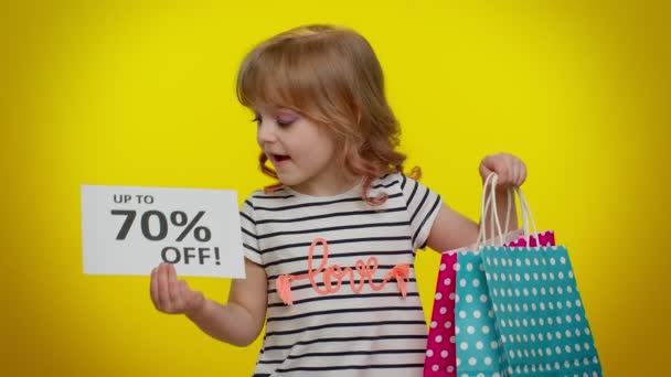 Kind kind meisje tonen boodschappentassen en tot 70 Procent Off inscripties banner tekst, Black Friday — Stockvideo